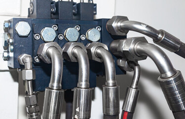 High pressure hydraulic hose system connected to steel pipes, close-up. Marine hydraulics.