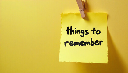 Yellow sticky note hanging on the wall saying things to remember
