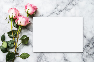 A blank white postcard, a few pink roses on the left side of it, a light gray marble texture background