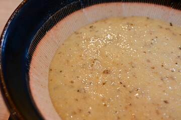 Grated Japanese yam, in mortar, close-up.