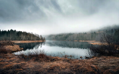 Fototapeta premium A lake with a cloudy sky in the background