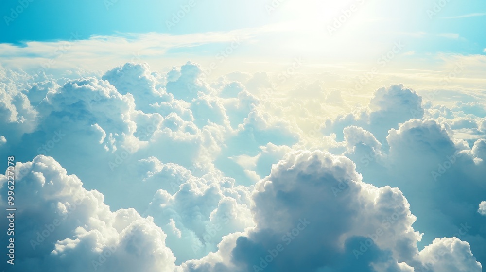 Poster a breathtaking view of fluffy white clouds against a deep blue sky, with sunlight streaming through,