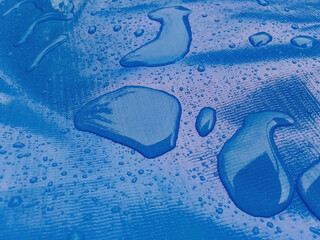 clear water drops on the surface of the blue carpet