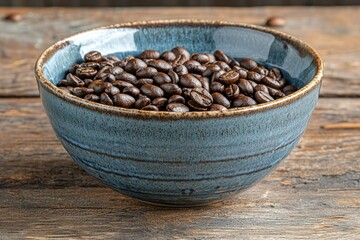 Coffee Beans in Blue Glazed Bowl on Rustic Wooden Surface