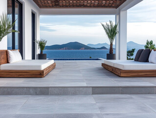 Fototapeta premium Contemporary outdoor lounge area with sea views and palm trees on a sunny day by a luxury villa