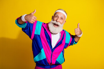 Photo of attractive funny retired sportsman retro sportswear showing two thumbs up emtpy space...