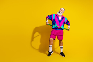 Full size photo poster of handsome granddad sportsman hulahoop look empty space wear vintage sportswear isolated on yellow color background