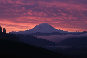 A mountain range with a large mountain in the background