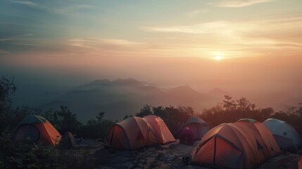 A stunning view of tents set up on a mountain peak, basking in the light of a breathtaking sunset, capturing the sense of adventure and peace.