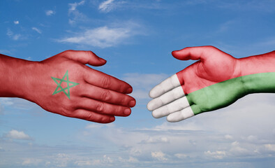 Madagascar and Morocco country handshaking with flags, consensus concept international co-operation illustration