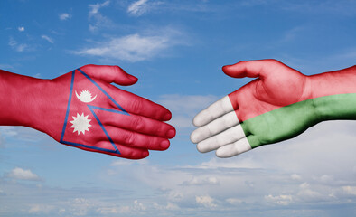 Madagascar and Nepal country handshaking with flags, consensus concept international co-operation illustration