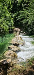 Stone bridge in Sentierelsa Trail, Colle di Val d'Elsa, Italy. June 26, 2024. Stone way over the river.