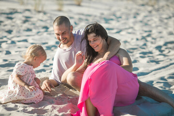Obraz premium Holiday travel concept, Summer vacations. Happy family are having fun on a tropical beach in sunset.