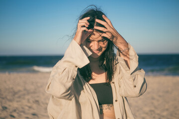 Obraz premium Portrait of a very happy young woman loving the life shes living having fun on the beach