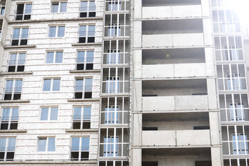 An unfinished modern multi-storey building. High-rise building in the city