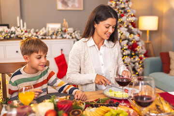 Young mother and son celebrating Christmas with family at home