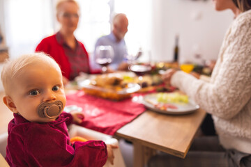 Baby girl at family Christmas dinner