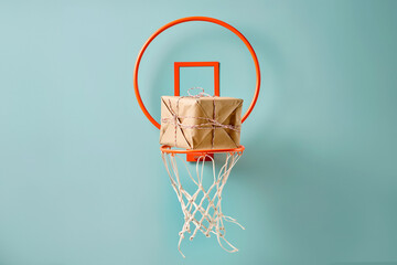 Giftbox is falling in basketball hitting net. A parcel wrapped in craft paper is falling inside the basketball hoop. Success in action, right choice, good work concept. High quality delivery service