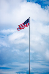 Patriotic waving american flag in overcast cloudy day