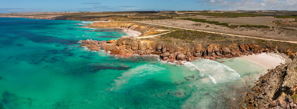 Aerial panorama of a sheltered coastal bay surrounded by eroded cliffs