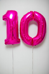 pink number 10 balloons on white background