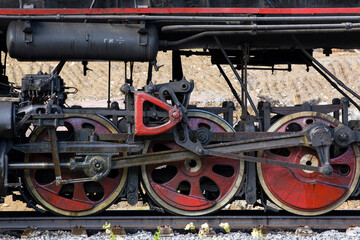 Close-up of part of an old black steam locomotive