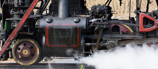 Close-up of part of an old black steam locomotive