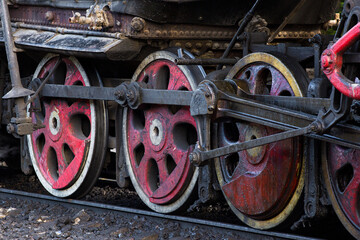 Close-up of part of an old black steam locomotive