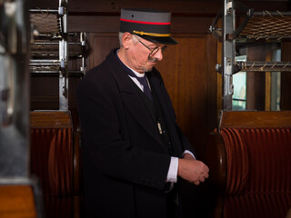 Vintage train conductor in antique train