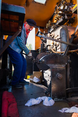 Steam train machinist working on locomotive