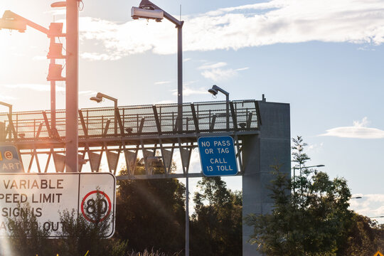 Light flare over signage at toll road start point with e tag e pass sign