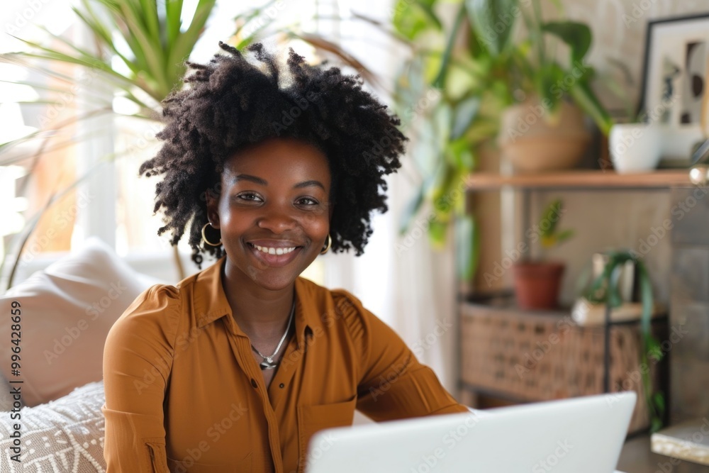 Poster a person sits in front of a laptop with a focused expression, possibly working or studying
