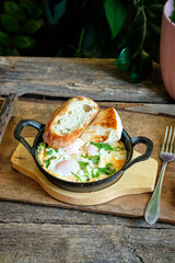 Scrambled eggs with basil, cheese and toast.