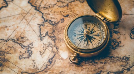 An antique compass placed on a faded old map, evoking a sense of adventure and historical discovery