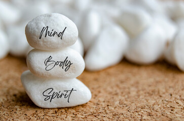 Mind, Body and Spirit text on white stones. Meditation and peace concept