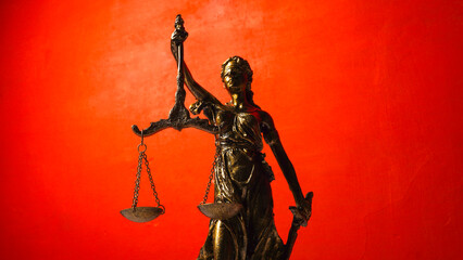 statue of Themis, the Greek goddess of justice on a red background. concept of justice