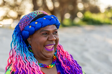 Happy portrait of First Nations Australian Torres Strait Islander woman in her late fifties at beach