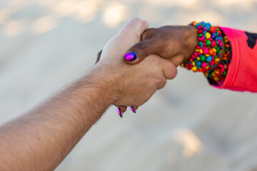 Torres Strait Islander woman shaking hands with Caucasian man