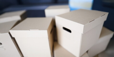 Close-up of empty cardboard boxes with covers container for storage things. Full packages of different stuff sorted separately. Storage, relocation concept