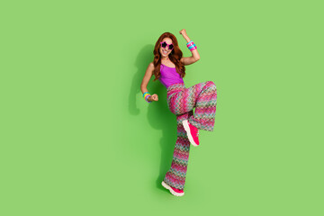 Full body portrait of nice young woman raise fists empty space isolated on green color background