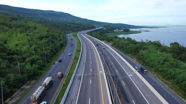 The elevated road and expressway along the river winds along the beautiful curves of the mountains in the rainy season, with the green trees on both sides of the Lam Takhong Dam, Nakhon Ratchasima Pro