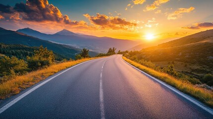 Serene asphalt road with stunning mountain scenery under a sunset sky High quality image