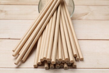 Bamboo drinking straws on wooden table, closeup