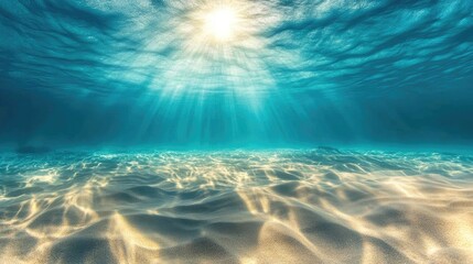 Underwater photo capturing sunlit sand dunes at the sea floor with turquoise water in the distance creating an abstract marine backdrop