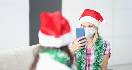 Portrait of woman take video of friend on smartphone, content for internet channel. Celebrating new year with friend during quarantine. Friendship concept
