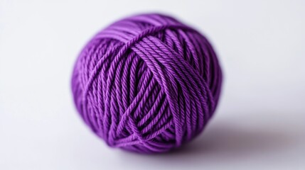 Close up of a purple yarn ball on a white background ideal for craft and knitting themes