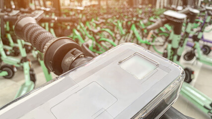 Closeup of Electric Scooter Handlebar with Smartphone Mount, Modern Urban Mobility Solution for Rental Services, Eco-Friendly Commuting, and Sustainable Transportation.