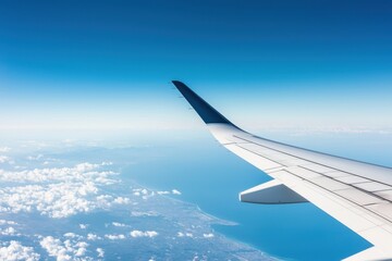 Fototapeta premium Airplane wing over clouds and blue sky, scenic view from window, travel experience.