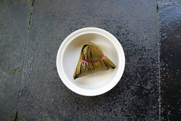 Bacang or bakcang. Chinese savoury sticky rice dumplings in bamboo leaves wrapping.  It contains meat inside the taste very delicious.