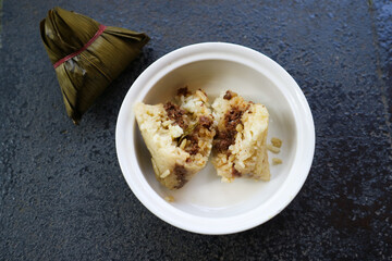 Bacang or bakcang. Chinese savoury sticky rice dumplings in bamboo leaves wrapping.  It contains meat inside the taste very delicious.